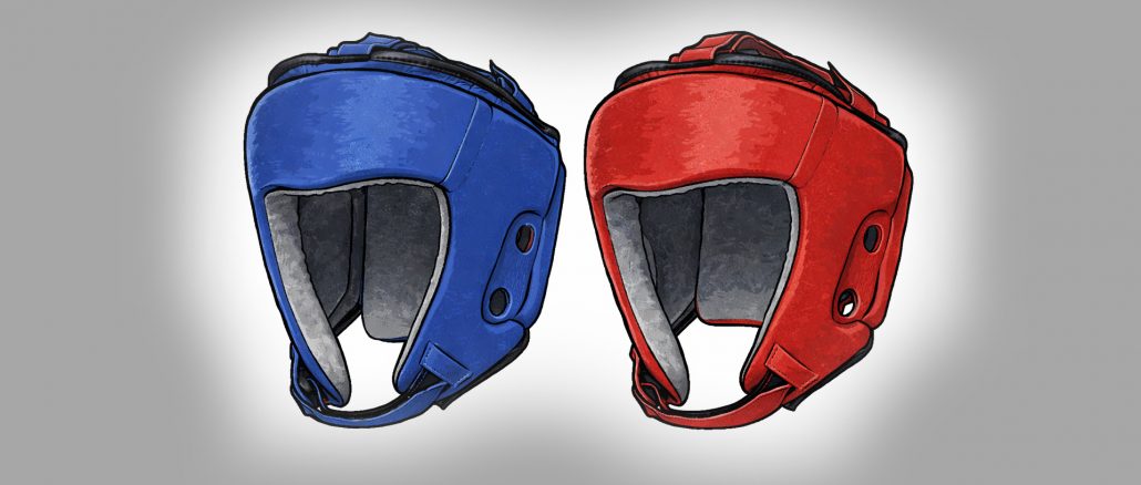 Zwei Kopfschützer in blauer und roter Farbe, wie sie im olympischen Boxen verwendet werden.