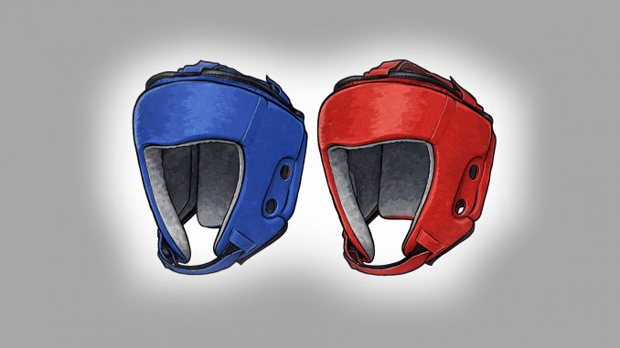 Zwei Kopfschützer in blauer und roter Farbe, wie sie im olympischen Boxen verwendet werden.